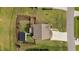 Beautiful aerial view of a landscaped property with a manicured lawn and a charming home with a large driveway at 55 Prospectus Ln, Franklinton, NC 27525