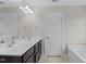 Bathroom featuring a dual sink vanity with granite counters and dark wood cabinets at 55 Prospectus Ln, Franklinton, NC 27525