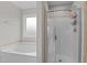 Bathroom featuring a glass-enclosed shower with tile surround and separate tub at 55 Prospectus Ln, Franklinton, NC 27525