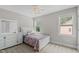 Light and airy bedroom featuring a patterned floral comforter, ceiling fan, and dresser at 55 Prospectus Ln, Franklinton, NC 27525