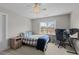 Bedroom with a checkered comforter, ceiling fan, and desk area, bathed in light at 55 Prospectus Ln, Franklinton, NC 27525