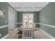 Elegant dining room with decorative ceiling, large window, and ample seating for entertaining guests at 55 Prospectus Ln, Franklinton, NC 27525