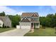 Beautiful two-story home with a two-car garage, inviting front porch, and professionally landscaped yard at 55 Prospectus Ln, Franklinton, NC 27525