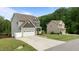Charming two-story home featuring a two-car garage, well-maintained lawn, and a welcoming driveway at 55 Prospectus Ln, Franklinton, NC 27525