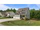 Attractive two-story home featuring a two-car garage, well-manicured lawn, and inviting front porch at 55 Prospectus Ln, Franklinton, NC 27525