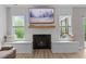 Close-up of a cozy fireplace flanked by built-in window seats, perfect for relaxing and enjoying the view at 55 Prospectus Ln, Franklinton, NC 27525