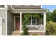 Charming front porch with stone pillars, a decorative wreath, and comfortable seating area at 55 Prospectus Ln, Franklinton, NC 27525