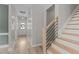 Inviting hallway showcasing modern staircase design and a welcoming front door with decorative wreath at 55 Prospectus Ln, Franklinton, NC 27525