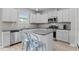 A bright kitchen featuring stainless steel appliances, granite countertops, and a breakfast bar with stylish seating at 55 Prospectus Ln, Franklinton, NC 27525
