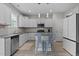 Well-lit kitchen with granite countertops, stainless steel appliances, and a stylish central island with seating at 55 Prospectus Ln, Franklinton, NC 27525