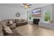 Bright living room with modern floors, shiplap accent wall, cozy fireplace, and large windows at 55 Prospectus Ln, Franklinton, NC 27525