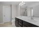 A main bathroom featuring a dual sink vanity with granite counters and dark wood cabinets at 55 Prospectus Ln, Franklinton, NC 27525