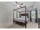 This main bedroom features a decorative ceiling fan, a canopy bed, and large windows at 55 Prospectus Ln, Franklinton, NC 27525