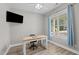 Bright home office with a modern desk, comfortable chair, and a large window providing natural light at 55 Prospectus Ln, Franklinton, NC 27525
