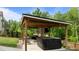 Outdoor living space with hot tub and comfortable seating for entertaining at 55 Prospectus Ln, Franklinton, NC 27525