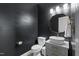 Stylish powder room features a vessel sink, dark accent wall, and modern gold-tone fixtures at 55 Prospectus Ln, Franklinton, NC 27525
