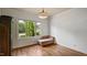 Bedroom showcasing hardwood floors, a large window with neighborhood views, and neutral paint at 603 Hawks Ridge Ct, Apex, NC 27539