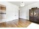 Bright bedroom with wood floors, white trim, walk-in closet, and en-suite bath with walk-in shower at 603 Hawks Ridge Ct, Apex, NC 27539