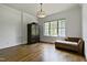 Bedroom with a large window, hardwood floors, and a comfortable seating area at 603 Hawks Ridge Ct, Apex, NC 27539