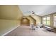 Spacious bonus room with neutral carpeting, ceiling fan, and flexible design for multiple uses at 603 Hawks Ridge Ct, Apex, NC 27539