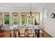 Dining room table set near windows and door, letting in natural light at 603 Hawks Ridge Ct, Apex, NC 27539