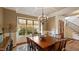 Formal dining area boasts an elegant chandelier and large window at 603 Hawks Ridge Ct, Apex, NC 27539