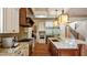 Modern kitchen features granite countertops, stainless steel appliances, custom cabinetry, and a center island with seating at 603 Hawks Ridge Ct, Apex, NC 27539