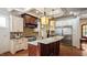 Bright kitchen boasts a large island with granite countertop and stainless steel appliances at 603 Hawks Ridge Ct, Apex, NC 27539