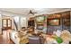 Inviting living room featuring a stone fireplace, custom built-ins, and plush sofas, perfect for cozy evenings at 603 Hawks Ridge Ct, Apex, NC 27539