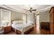 Spacious primary bedroom featuring a tray ceiling and hardwood floors at 603 Hawks Ridge Ct, Apex, NC 27539