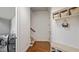 Mud room featuring a utility bench, coat rack, shelving, and access to the laundry room and staircase at 603 Hawks Ridge Ct, Apex, NC 27539