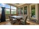 Covered patio with stone flooring, an outdoor table, seating, and door at 603 Hawks Ridge Ct, Apex, NC 27539
