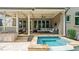 Inviting covered patio with a full outdoor kitchen and adjacent spa at 603 Hawks Ridge Ct, Apex, NC 27539