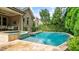 Gorgeous backyard pool with stone accents and lush landscaping at 603 Hawks Ridge Ct, Apex, NC 27539