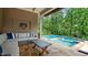 Outdoor patio with a sofa and a clear view of the pool and green trees at 603 Hawks Ridge Ct, Apex, NC 27539