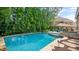 Beautiful pool surrounded by lush greenery in a private backyard at 603 Hawks Ridge Ct, Apex, NC 27539
