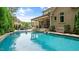 Relaxing backyard pool area with a covered patio, built-in grill, and comfortable seating, perfect for outdoor entertaining at 603 Hawks Ridge Ct, Apex, NC 27539