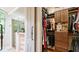 View from bathroom looking into a walk-in closet with custom wood shelving and ample storage at 603 Hawks Ridge Ct, Apex, NC 27539