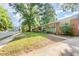 Charming red brick house featuring a well-maintained lawn and mature shade trees at 603 Kildaire Farm Road Rd, Cary, NC 27511