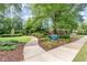 Scenic view of Kay Strusolino Park with lush landscaping and a charming brick house nearby at 603 Kildaire Farm Road Rd, Cary, NC 27511