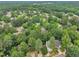 Aerial view showcases a house situated in a lush neighborhood, enveloped by verdant trees and mature landscaping at 608 Cross Timbers Dr, Durham, NC 27713
