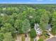 Aerial view of a house nestled in a lush, green neighborhood provides a sense of community and natural beauty at 608 Cross Timbers Dr, Durham, NC 27713