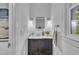 Bathroom featuring a dark vanity, marble countertop and modern lighting fixtures offers a clean and stylish space at 608 Cross Timbers Dr, Durham, NC 27713