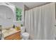 Bathroom with a window and shower curtain and a traditional wooden vanity offers a functional and comfortable space at 608 Cross Timbers Dr, Durham, NC 27713