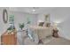 Bright bedroom with large windows, ceiling fan, hardwood floors and neutral color palette at 608 Cross Timbers Dr, Durham, NC 27713
