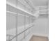 Walk-in closet featuring built-in white shelving and a clothing rod at 608 Cross Timbers Dr, Durham, NC 27713
