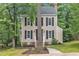 Traditional two-story home boasting a timeless design, enhanced by mature trees and a neatly landscaped front yard at 608 Cross Timbers Dr, Durham, NC 27713
