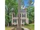 Charming two-story home with black shutters, a brick chimney, and lovely landscaping offers curb appeal and beauty at 608 Cross Timbers Dr, Durham, NC 27713