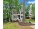 Charming two-story home featuring a well-manicured lawn, complemented by mature trees, and a welcoming front porch at 608 Cross Timbers Dr, Durham, NC 27713