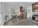 Bright kitchen features an eat-in area, stainless steel appliances, wooden cabinets, and wood look flooring at 608 Cross Timbers Dr, Durham, NC 27713